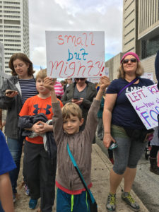 Amy Nosek with pussyhat and son during protest